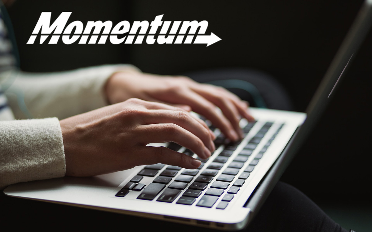 Woman's hands typing on a laptop keyboard.